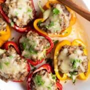 Stuffed peppers made without tomato sauce served on a platter.