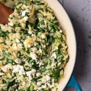 A big pan of orzo with spinach and feta.
