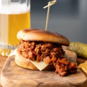 Ground chicken sloppy Joe with a glass of beer in the background.