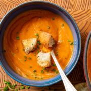 A bowl of butternut squash and tomato soup.