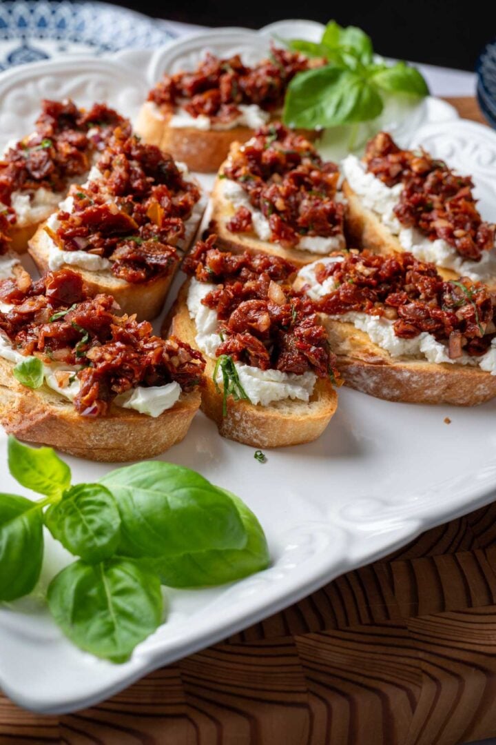 Sun-dried tomato bruschetta on a serving plate.