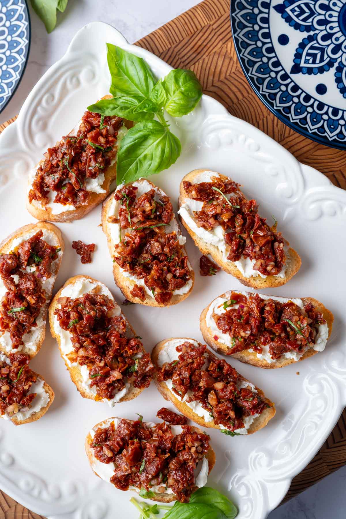 Sun-dried tomato bruschetta on a serving plate.