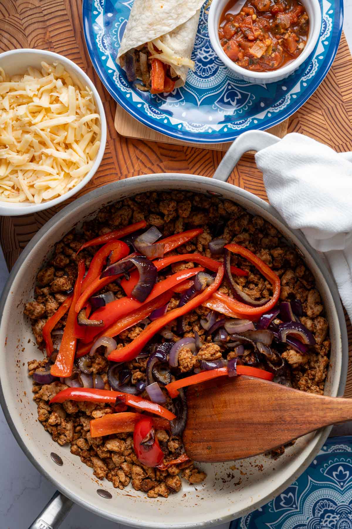 The ground turkey fajitas with peppers and onions in a skillet.
