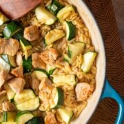 A skillet (one pan) with lemon chicken orzo pasta.