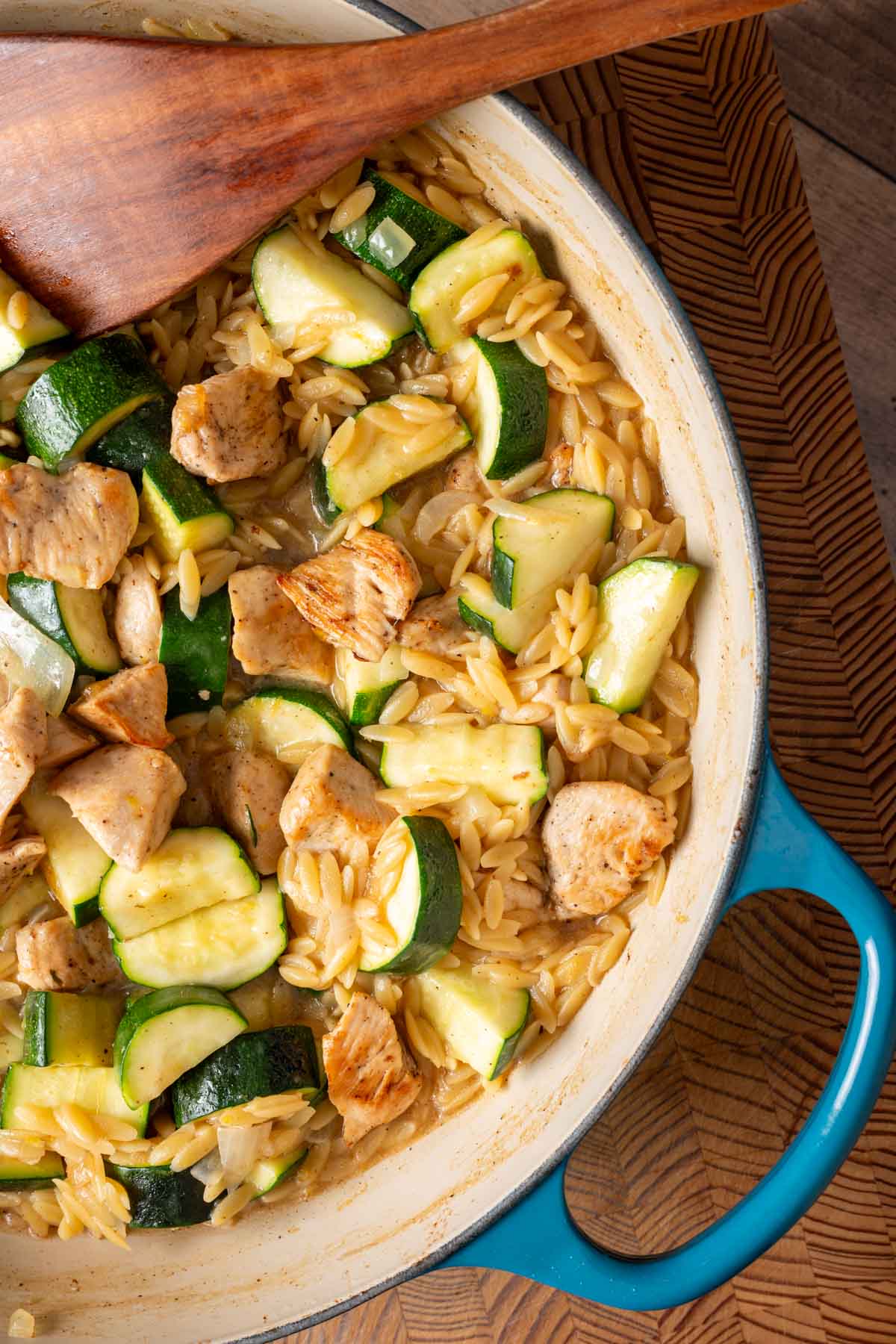 A skillet (one pan) with lemon chicken orzo pasta.
