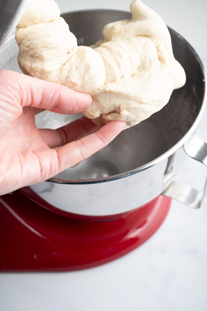 Kneading the same-day pizza dough in a stand mixer.