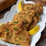 Baked and breaded chicken cutlets on a plate.