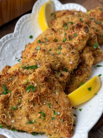 Baked and breaded chicken cutlets on a plate.