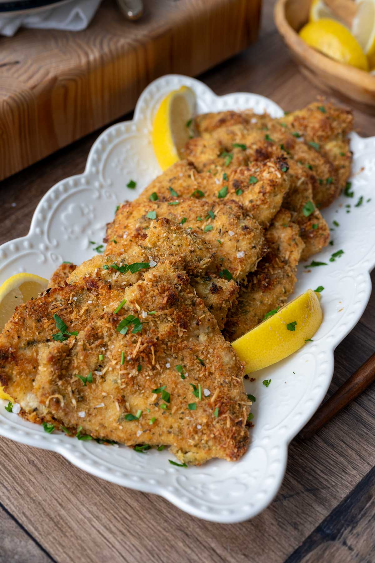 Baked and breaded chicken cutlets on a plate.