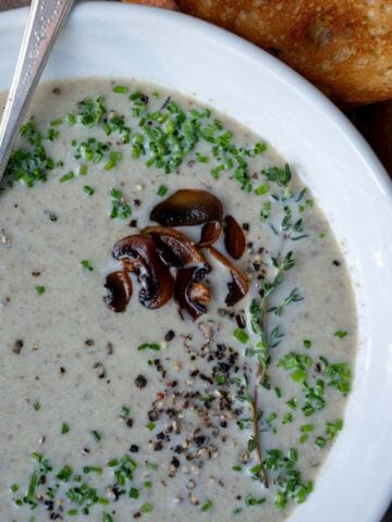 A bowl of creamy mushroom and leek soup.