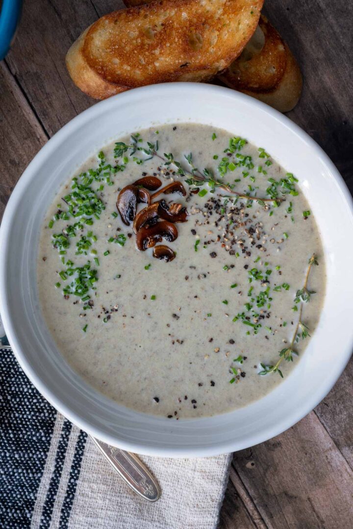 A bowl of creamy mushroom and leek soup.
