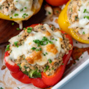 Salmon stuffed bell peppers in a casserole dish.