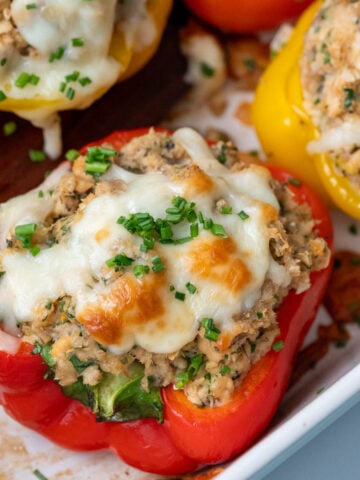 Salmon stuffed bell peppers in a casserole dish.