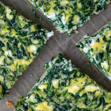 Four slices of tortilla quiche bake with spinach and feta.