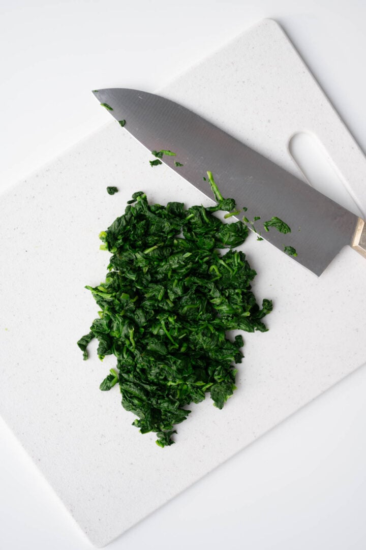 Chopped spinach on a cutting board.