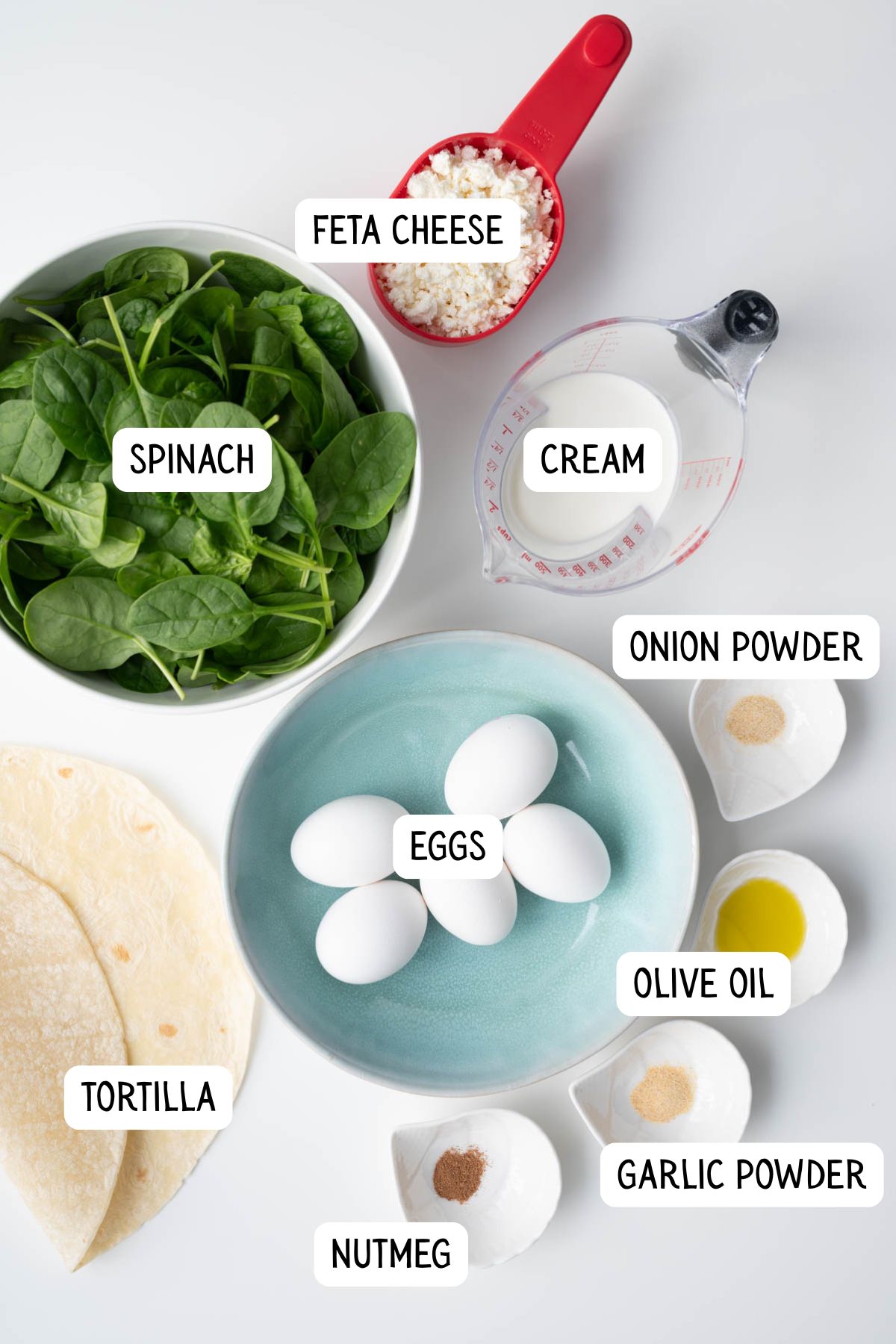 The ingredients needed to make a tortilla quiche bake with spinach and feta.