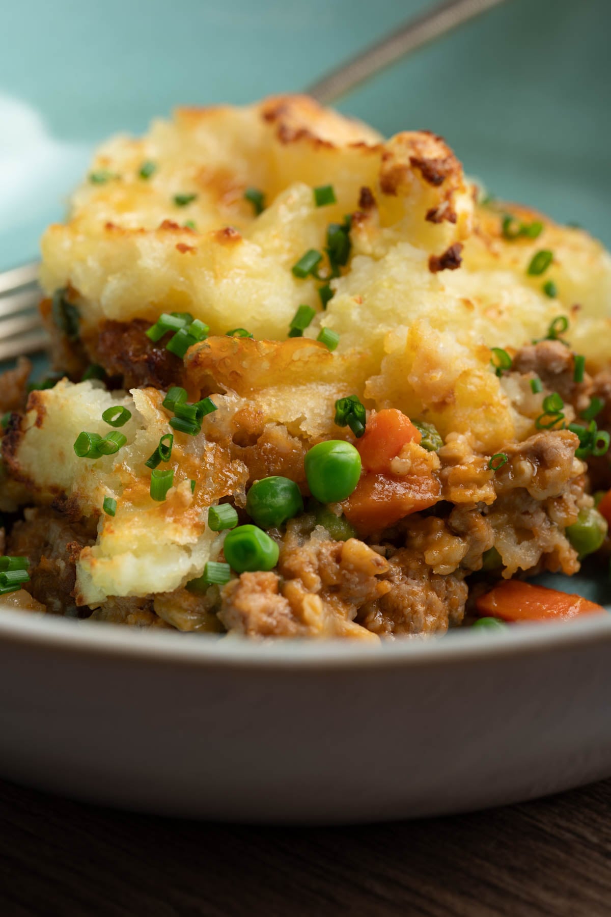 Shepherd's pie with ground pork in a bowl.
