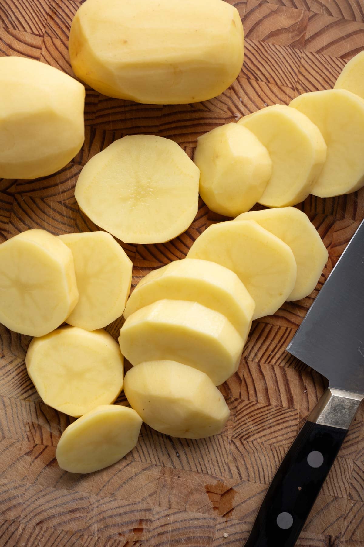 Sliced potatoes on a cutting board.
