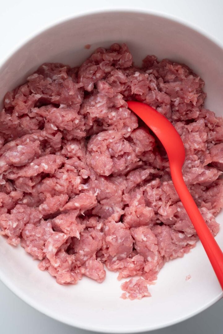 Ground pork in a small bowl.