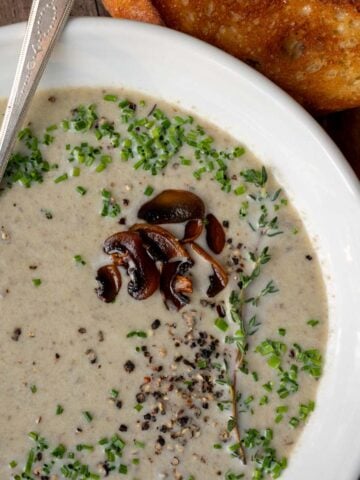 A bowl of creamy mushroom and leek soup.